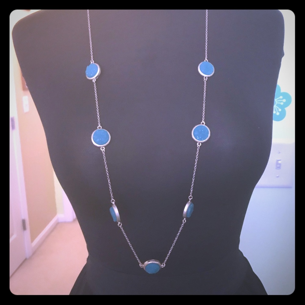 Gold necklace with blue druzy accent pieces.